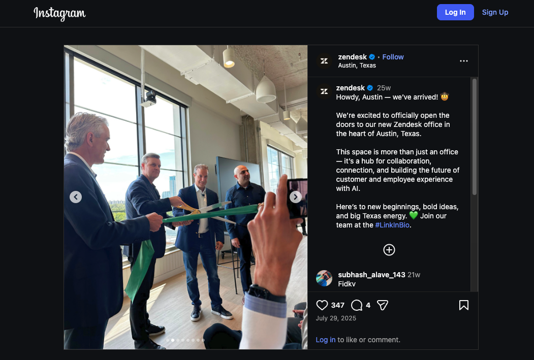Four men dressed in suits, cutting a green ribbon for the opening of their new office.