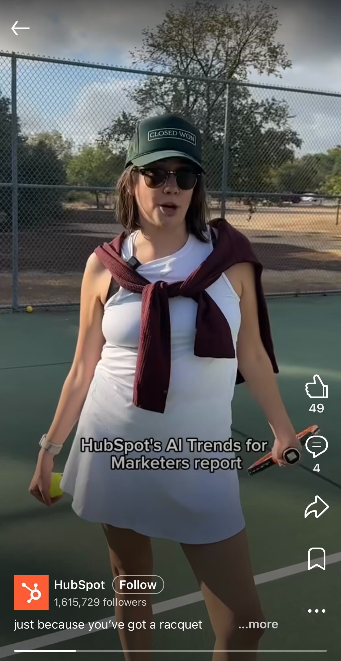 Woman standing on a tennis court with a racket, wearing a white dress, sunglasses, and a green cap, with on-screen text about HubSpot's AI trends for marketers.