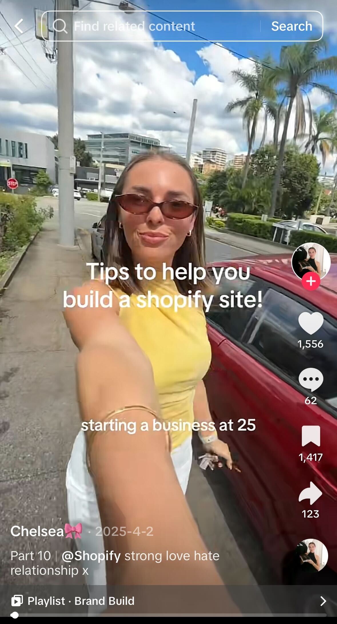 Young woman filming a selfie-style video beside a red car, wearing sunglasses and a yellow top, with on-screen text about tips for building a Shopify website.
