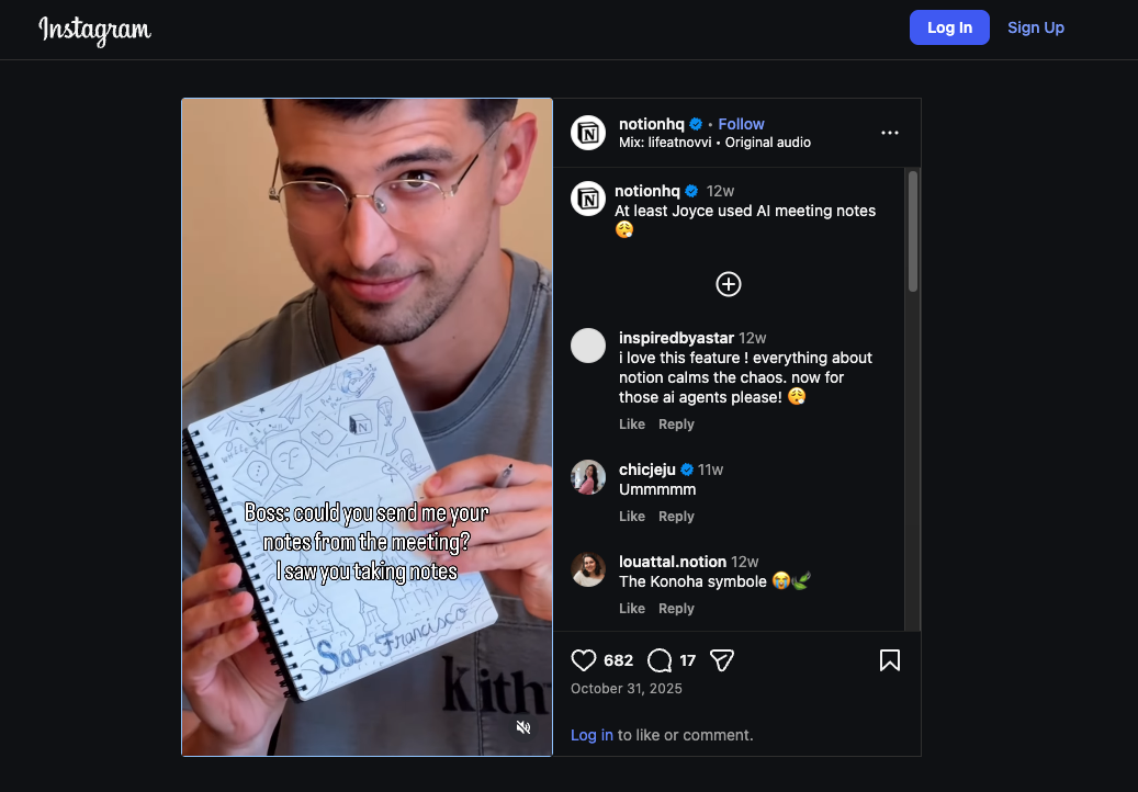 Man in glasses holding an open notebook filled with random doodles instead of notes, smiling mischievously at the camera.